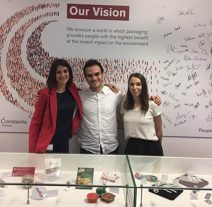 Cflex employees in front of Our Vision poster