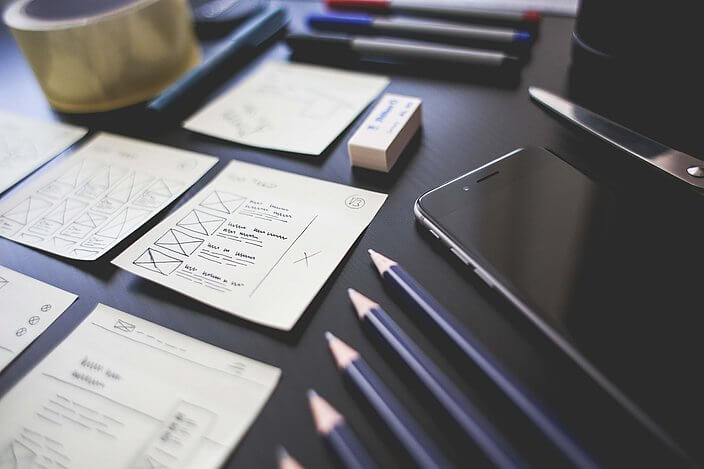 desk papers pencils phone